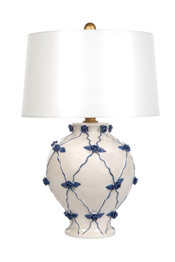 Blue floral design adorns white lamp. 